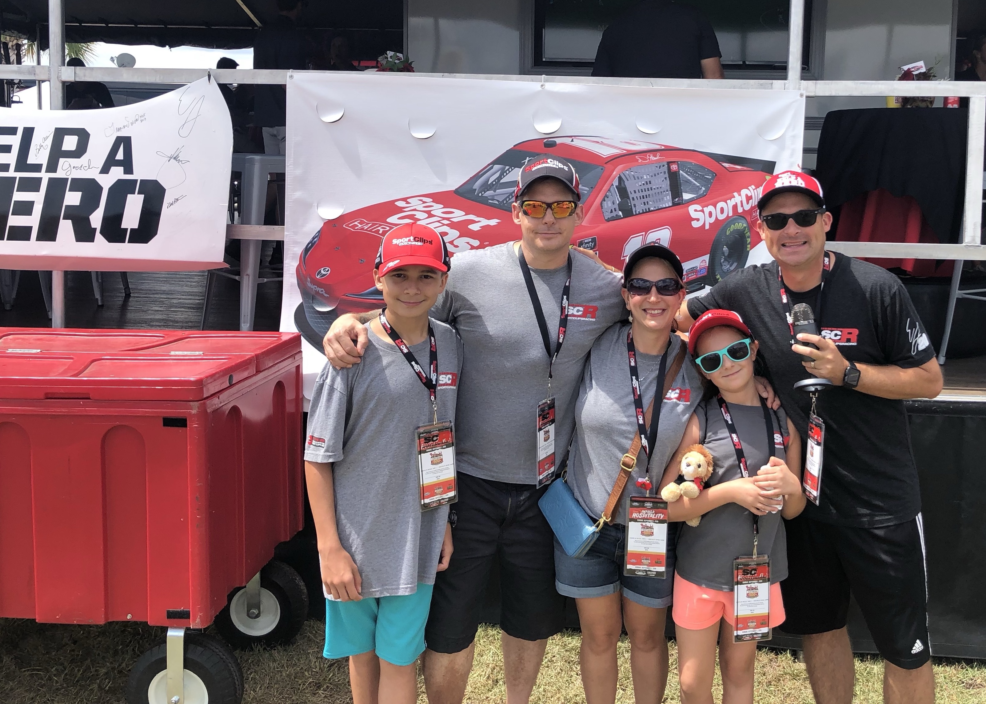 Chad Jordan and Wiley Family posing at racetrack